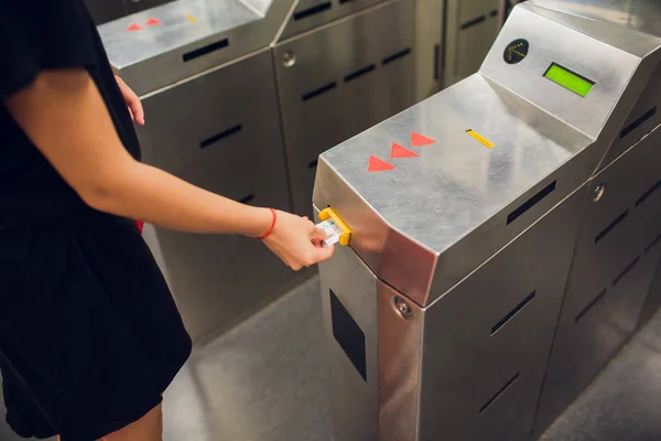 Mujer validar billete en validar dispositivo de máquina para entrar en estación de metro en español . — Foto de Stock