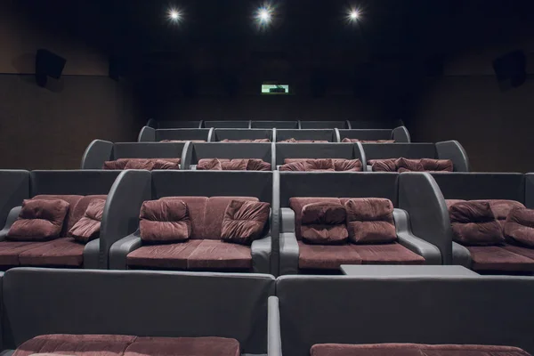 Empty silver cinema room interior with white screen and seats