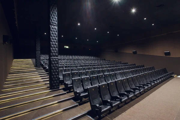 Empty silver cinema room interior with white screen and seats