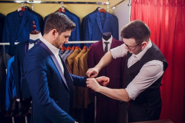 adam deposundaki takım elbise satın alıyor