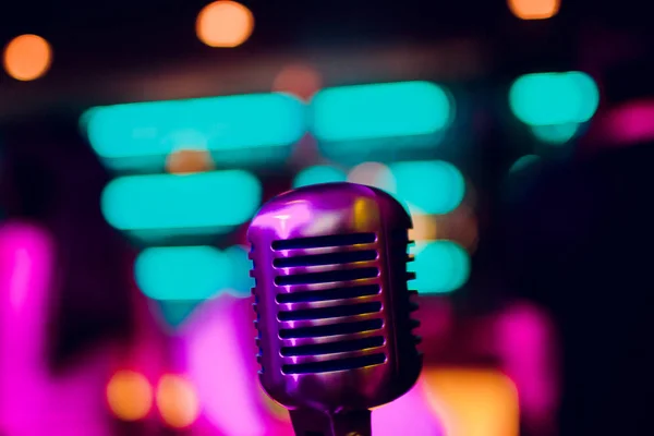 microphone on stand up comedy stage with reflectors ray, high contrast image
