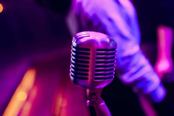 microphone on stand up comedy stage with reflectors ray, high contrast image