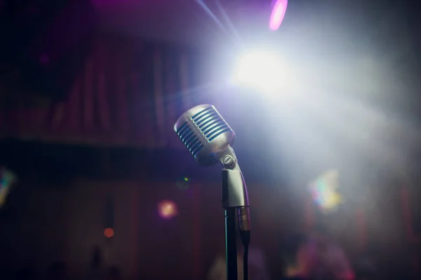 Modern microphone for singing against beautiful blurry colored bokeh. — Stock Photo, Image