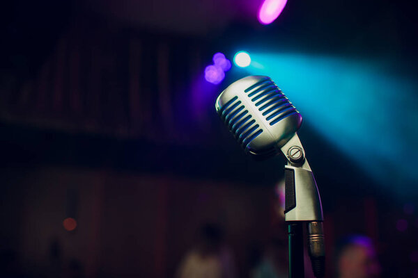 modern microphone for singing against beautiful blurry colored bokeh.