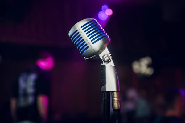 Modern microphone for singing against beautiful blurry colored bokeh. — Stock Photo, Image