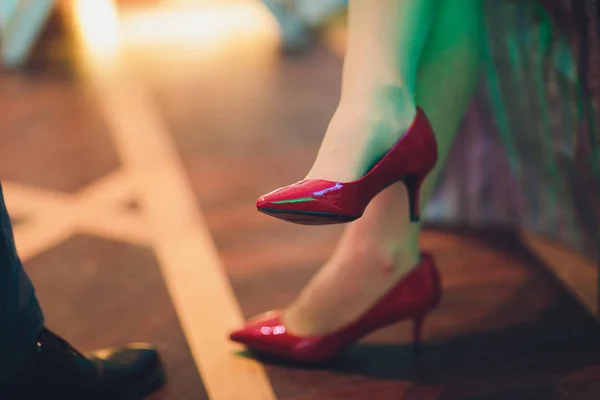 Close up cropped photo of beautiful legs of the business lady in high hills shoes. she is sitting in the office.