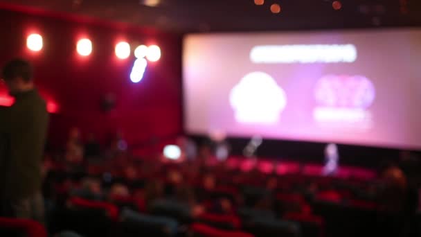 Viewers watch blue star at cinema, long exposure, blue glow. — Stock Video