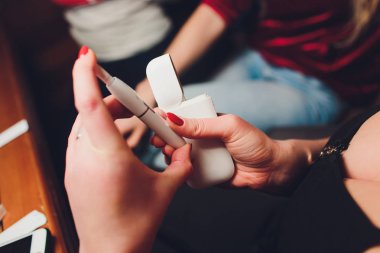 Iqos ısı-değil-yanık tütün ürün teknolojisi. E-Sigara İçilmeyen önce elinde tutan kadın.
