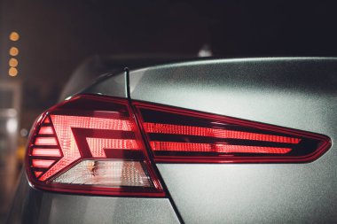Modern prestijli arabayla yakın bir açıdan, Otomobil Fuarı'nın arka ışıkları.