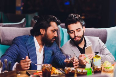 İki adam Bar Hold gözlüklü oturmak, kokteyl Içme, neşeli arkadaşlar toplantı Bar konuşma Iletişim.