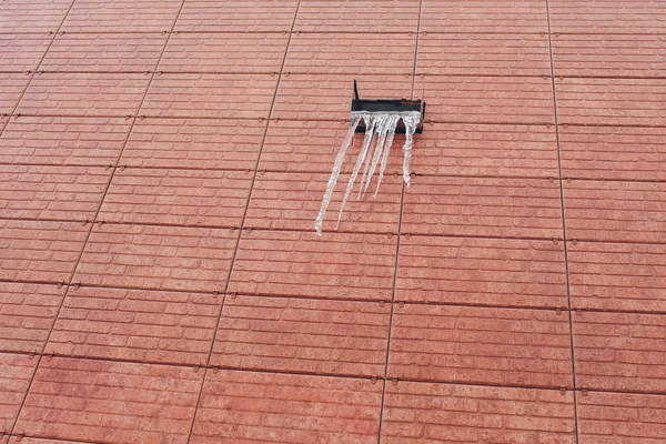 屋顶上的多雪的太阳能电池板。冰雪从屋顶太阳能电池板融化。阳光照在屋顶上被白雪覆盖的太阳能电池板上。屋顶上多雪的太阳能电池板上的电流. — 图库照片