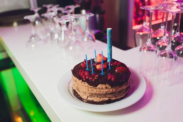 Birthday cake with candles, bright lights bokeh. — Stock Photo, Image