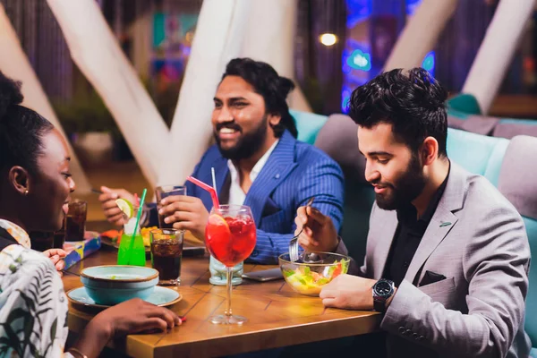 businessmen Friends having fun at the bar, drinking cocktails.