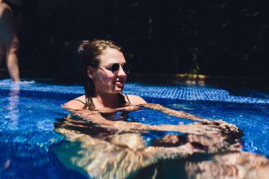 Kadın havuzda bir adam boğur.