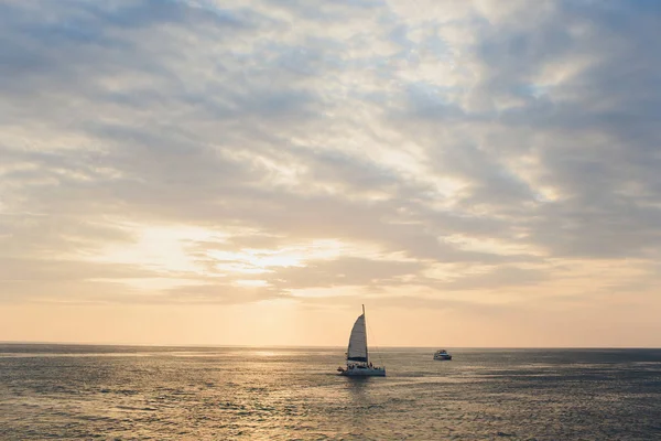 Jacht segelt gegen Sonnenuntergang. Urlaubslandschaft mit Skyline-Segelboot und zwei Möwen. Yachttourismus - maritimer Abendspaziergang. Romantischer Ausflug auf einer Luxusjacht während des Sonnenuntergangs am Meer. — Stockfoto