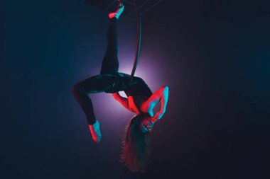 Hava acrobat içinde belgili tanımlık çalmak. Genç bir kız akrobatik öğeleri hava ringde gerçekleştirir..