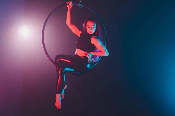 空中杂技演员在圆环。一个年轻女孩在空气环中表演杂技元素. — 图库照片