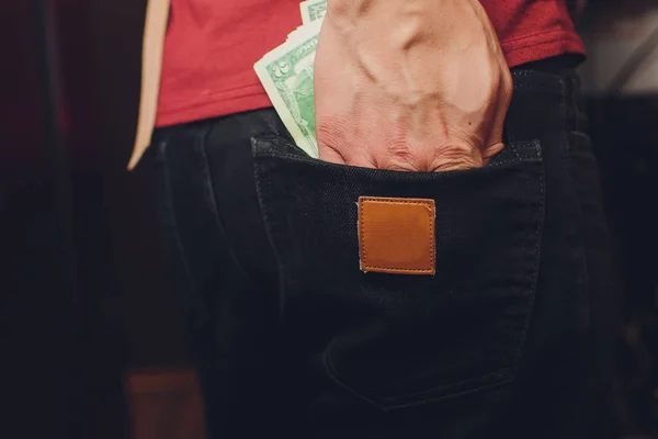 Ο άστεγος κρατάει το χαρτονόμισμα των δολαρίων στο χέρι του. Επιλεκτική εστίαση σε δολάρια νομοσχέδιο. — Φωτογραφία Αρχείου