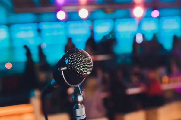 Microphone. Retro microphone. A microphone on stage. A pub. Bar. Restaurant. Classic. Evening. Night show. European restaurant. European bar. American restaurant. American bar.