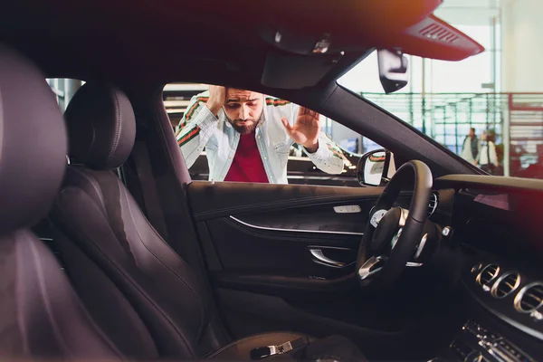 man forgot the key inside of his car.Transportation, crime and ownership concept.