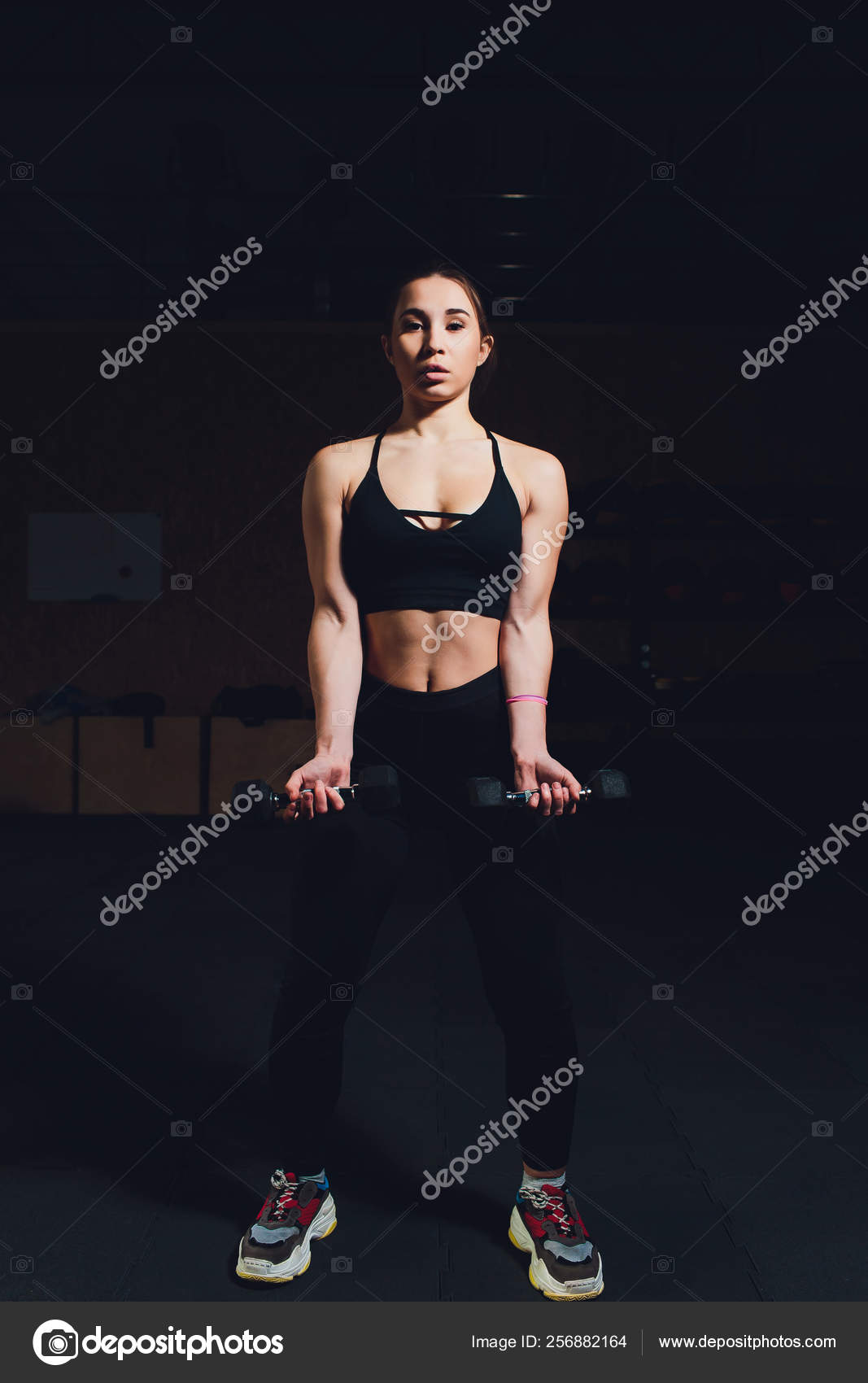 Body And Mind Workout In Loft Fitness Studio Closeup On Fitness Woman Taking Dumbbell From The Floor In Urban Loft Gym Stock Photo C Vershinin Photo