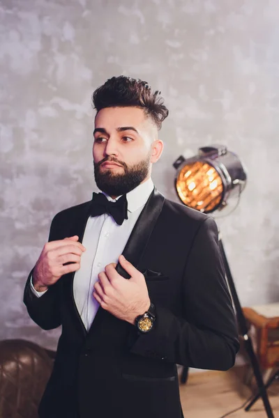 Portrait of handsome stylish man in elegant black suit. — Stock Photo, Image