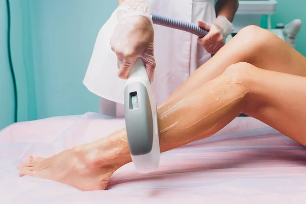 Woman getting laser treatment in medical spa center, permanent hair removal concept.