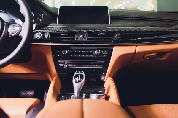 Modernes Luxusauto im Inneren. Interieur des modernen Prestigeautos. bequeme lederbraune Sitze. orange perforiertes Ledercockpit. — Stockfoto
