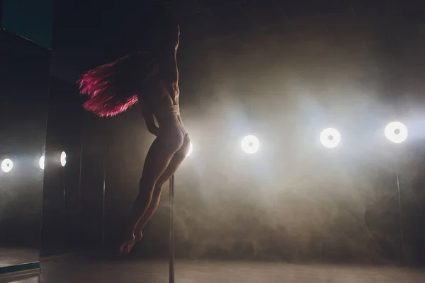 빛과 연기와 어두운 내부에서 춤추는 젊은 슬림 여자 폴. — 스톡 사진