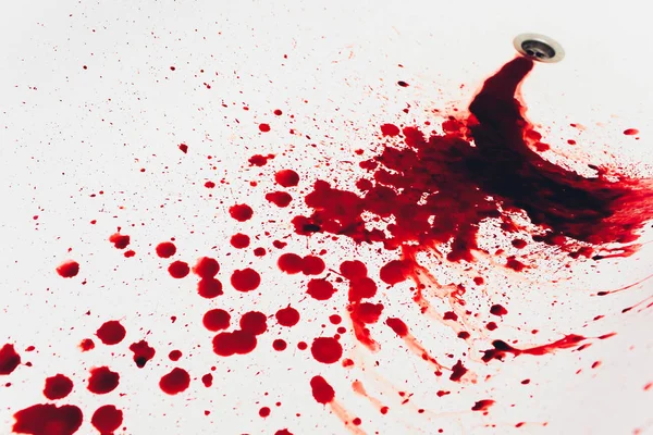 Blood draining from white bathroom basin. Bloody stains in the waterbasin hole. Sink run with blood floods. Red paint dripples to the washbowl drain. Accident with human injury. Bleeding in bathroom. — Stock Photo, Image