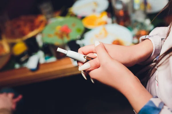 Calor-não-queimar a tecnologia do produto do tabaco. Mulher segurando e-cigarro na mão antes de fumar. — Fotografia de Stock