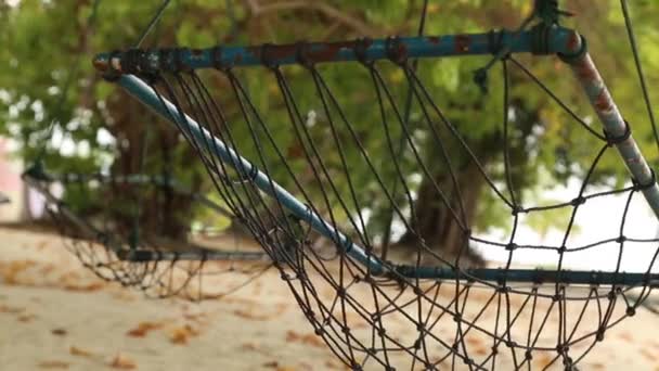 Empty hammock between palms trees at sandy beach. — Stock Video