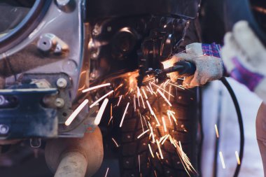 Otomotiv endüstrisinde profesyonel tamirci metal gövde arabalarını kıvılcımlarla dolduruyor..