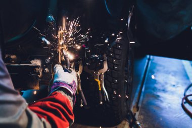 Otomotiv endüstrisinde profesyonel tamirci metal gövde arabalarını kıvılcımlarla dolduruyor..