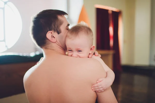 Small baby with his father. Father holds baby in his hands. — Stock Photo, Image