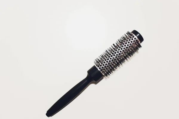 Round hairbrush with a handle on a white background. — Stock Photo, Image
