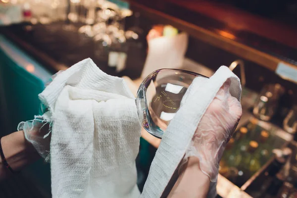 Le barman nettoie le verre sur le bar . — Photo