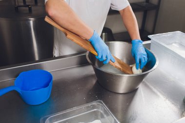 Geleneksel peynir yapımı bir küçük şirket. Peynir Maker eller yakın çekim üstten görünüm.