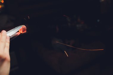 adam nargile atmosferik Siyah arka plan üzerinde kömürler değişen.