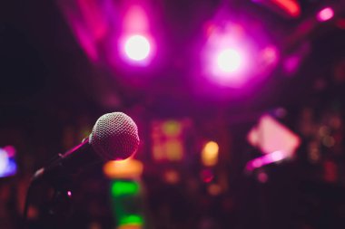 Sahnede oditoryumun arka planına karşı mikrofon.