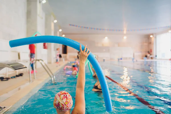 women trains in aqua aerobics, learn to swim.