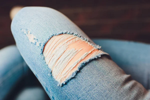 Woman in torn jeans blue texture fashion.