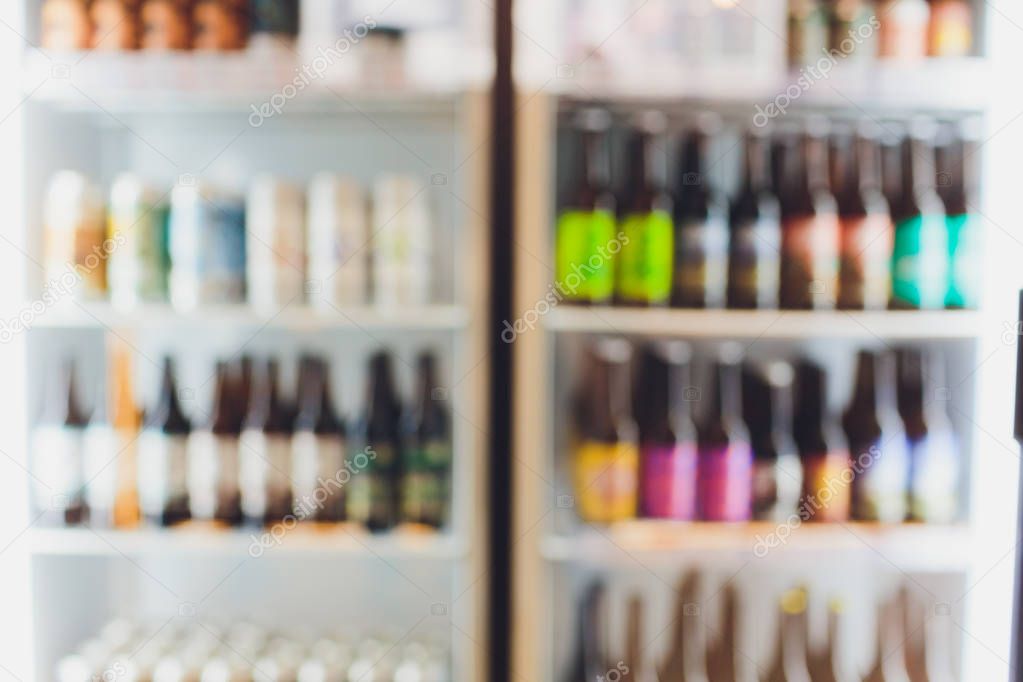 Background Blurred Defocused Beers are cooling in fridge, freezer or refrigerator shelf. Defocused Blurry Night life, Night Club, Bar, Pub, Store or Grocery Background concept image.