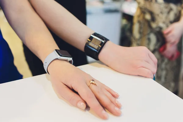 Photo of female hands touching screen generic design smart watch. Film effects, blurred background.