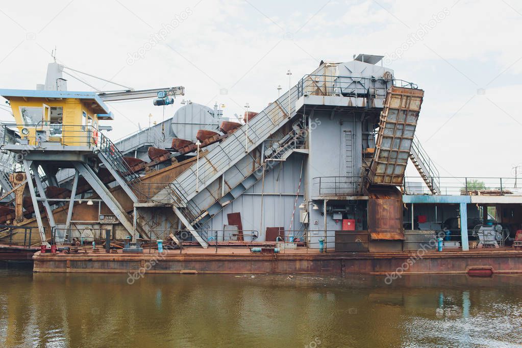 Dredger for absorption of trailer bunker during work on land reclamation for new ports. Suction dredge. Dredging in fairway of River. Cutter suction dredgers when working on land reclamation.