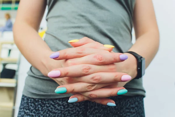 Womens hands. Fingers and multicolored nails, manicure. Beautiful female hands. Long nails multicolored.