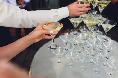 Şampanyalı şarap kadehleri piramidi. Şampanya bardaklara dökülür. Şampanya bardakları bir piramit ile olayın şenlikli dekorasyon. Sıçrama ve damla.