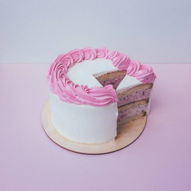 masa arka plan üzerinde krem şanti ile kek bir kesim.