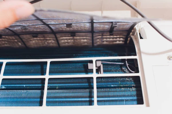 Male technician cleaning air conditioner indoors. service — Stock Photo, Image