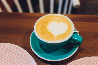 Bir fincan kahve, ahşap masa, üst manzara..